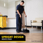 Worker demonstrating an upright design dustpan with long handle and broom in a modern lobby interior.