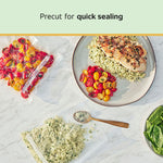 Overhead shot of sealed vacuum bags with cherry tomatoes and a plated meal on a marble surface and text about quick sealing