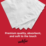 Stack of white Vanity Fair napkins fanned on a red background highlighting embossed shell pattern