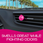 Pink circular vent air freshener clipped to a car vent with blurred palm trees outside and text banner below.