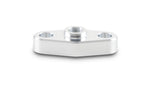 Centered polished aluminum oil inlet flange for turbo with visible center female thread and two countersunk bolt holes