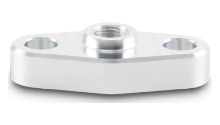 Close-up of a machined silver aluminum oil inlet flange with 1/8in NPT threaded center port and two bolt holes