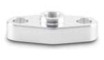 Low-angle view of a polished aluminum turbo oil inlet flange showing central female thread and two mounting holes