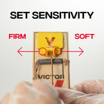 Close overhead graphic of Victor trap showing sensitivity adjustment with labels 'firm' and 'soft' and gloved hands