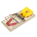 Single Victor wooden mouse trap with yellow trigger plate photographed at an angle on white background