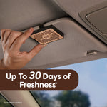Car visor with wood-grain rectangular air freshener clipped in place, overlay text about up to 30 days of freshness