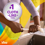 Close-up of hands wringing a saturated Viva paper towel over a sink with a '#1 cloth-like towel' badge overlay.