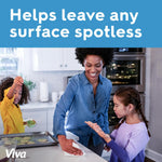 Lifestyle image of a person wiping a kitchen counter with a Viva paper towel while children watch