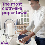 Lifestyle kitchen scene showing a person rinsing a plate at a sink with text calling the towel cloth-like