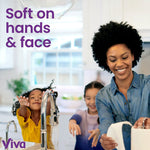 Smiling adult and children at a kitchen sink using Viva paper towels with text saying 'Soft on hands & face'
