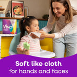 Mother wiping a child’s face with a Viva paper towel in a kitchen setting, product pack visible in background