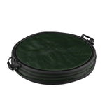 Folded green collapsible pop-up trash can with black zipper and carry handles shown flat on a white background