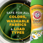 Close-up of a washing machine door with green laundry motion and part of an Arm & Hammer Clean Scentsations bottle at the edge.