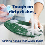 Person washing a green plate at a sink with soapy sponge and headline text tough on dirty dishes, not the hands that wash them