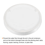 Underside view of a white ceramic plant saucer showing recessed feet and glazed finish