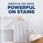 White child-sized T‑shirt on a hanger beside a woven basket and towel, headline reads “Gentle on skin, powerful on stains”