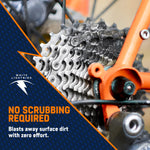 Close-up of a dirty bicycle cassette with White Lightning branding and overlay text saying no scrubbing required