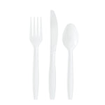 Three white plastic utensils - fork, serrated knife and spoon - on a white background