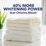 Stack of clean white towels on a bright surface with headline text claiming 40% more whitening power than chlorine bleach.