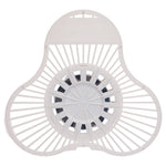 Top view of a white plastic urinal screen showing radial slats and a central circular vent area