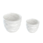 Pair of white wavy-textured ceramic planters photographed on a white background, showing interior rims.
