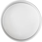 Empty silver aluminum round cake pan photographed from above on white background showing rim detail