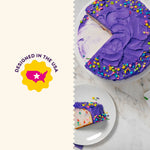 Sliced purple-frosted cake on a marble surface alongside a graphic saying designed in the USA