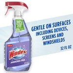 Windex ammonia-free spray bottle with purple liquid and label reading 'Windex' and 'Ammonia-Free' against soft blue background