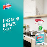 Windex logo and Windex with Vinegar spray bottle on a kitchen countertop with cooking utensils