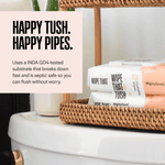 Stacked Wipe That Tush packs on a wicker shelf above a toilet with text about being septic-safe and fast breaking down.