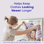 Lifestyle image of a woman and child playing with a towel in front of a washer, with headline about keeping clothes looking newer.