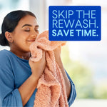 Woman smelling a soft pink towel with overlay text urging skipping the rewash to save time in a lifestyle laundry scene