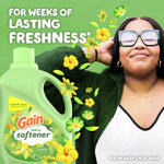 Smiling woman with eyes closed and Gain fabric softener bottle with yellow flowers and text about weeks of lasting freshness
