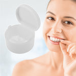 Smiling woman holding a clear dental aligner beside an enlarged open white retainer case with internal strainer.