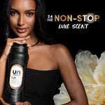 Lifestyle shot of a woman holding a black Downy Unstopables N.26 bottle with floral accents and "24 hr non-stop" text