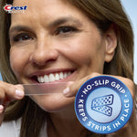 Close-up of a woman stretching a Crest whitening strip toward her teeth with no-slip grip feature badge