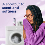 Woman hugging a purple sweater with a washing machine and a Downy Blends bottle blurred in the background