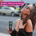 Laughing woman holding a tube of Grind charcoal toothpaste in a street-style lifestyle photo with promotional headline text