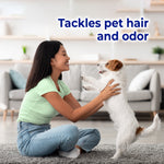 Woman kneeling on carpet playing with a small dog, headline text reads ‘Tackles pet hair and odor’ in product lifestyle image