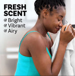 Woman smelling a towel with text saying Fresh Scent: Bright, Vibrant, Airy alongside teal-accent imagery