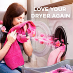 Woman smelling a pink towel near a front-load dryer with floral scent graphics and promotional text