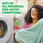 Woman holding folded laundry near a washing machine with gain Happy bottle blurred in background and safety text