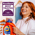 Smiling woman holding a Tide Ultra Hygienic Clean bottle with a 'BrandSpark Most Trusted' badge in the corner