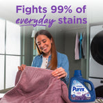 Lifestyle image of a smiling woman holding a towel with a Purex Fresh Lavender Fields detergent bottle and claim about fighting 99% of stains