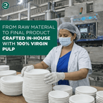 Factory worker wearing hairnet and mask handling stacks of white compostable plates and bowls in a production facility