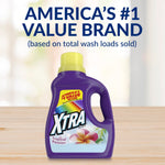 Single purple XTRA Tropical Passion detergent bottle on a wood surface under brand claim text