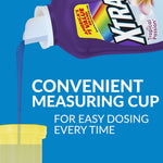Close-up of a purple Xtra detergent bottle pouring blue liquid into a yellow measuring cup with dosing text
