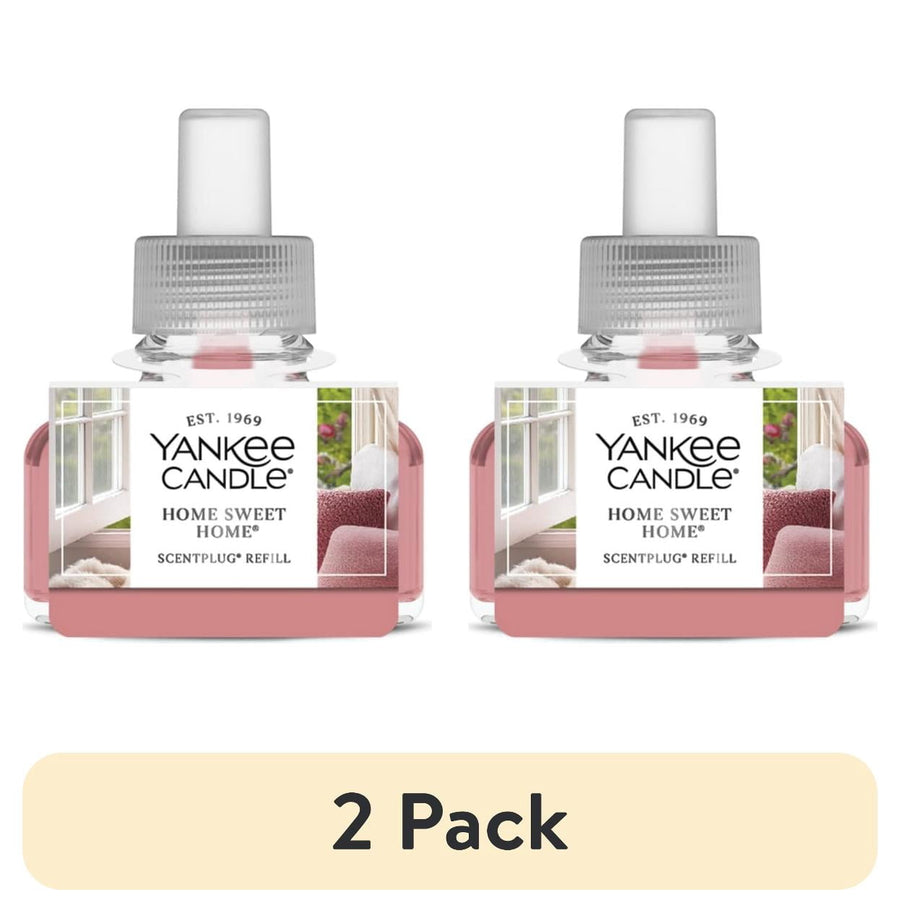 Two Yankee Candle Home Sweet Home ScentPlug refill bottles side-by-side with pink fragrance oil and labeled front panels.