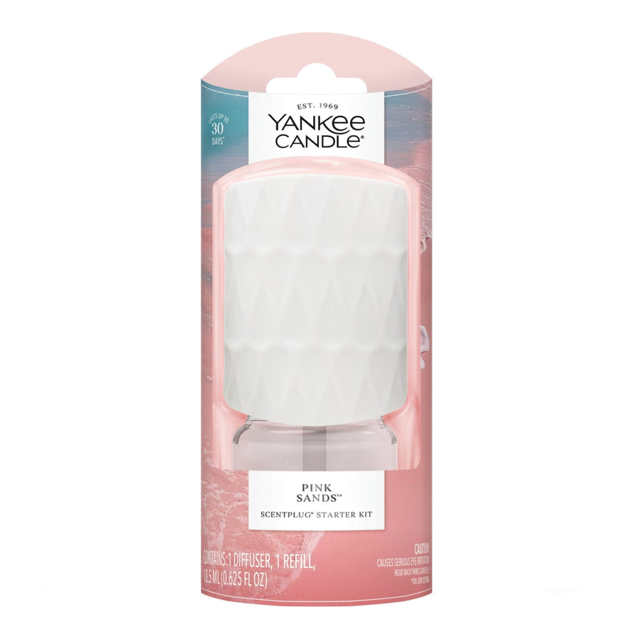 Yankee Candle Pink Sands ScentPlug starter kit in pink packaging showing diffuser and refill through clear blister window.