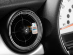 Single Yankee Candle Pink Sands vent stick clipped into a round car air vent shown in vehicle interior